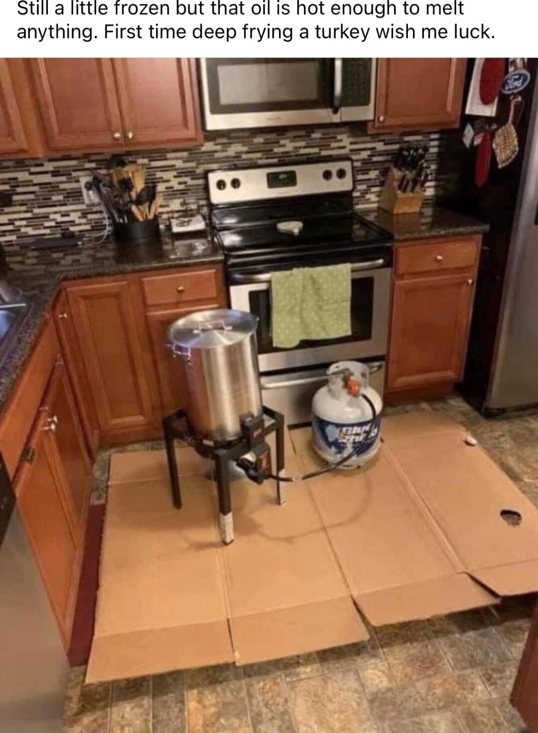 a little frozen but that oil Is hot enough to meit anything First time deep frying a turkey wish me luck