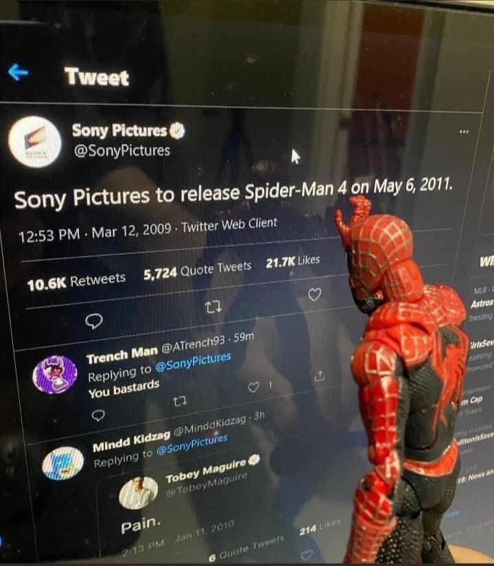 Sony Pictures to release Spider-Man 4 on May 6, 2011. Trench Man replying to SonyPictures: You bastards. Tobey Maguire replying to SonyPictures: Pain. A Spider-Man action figure is looking at the screen displaying a Twitter feed.