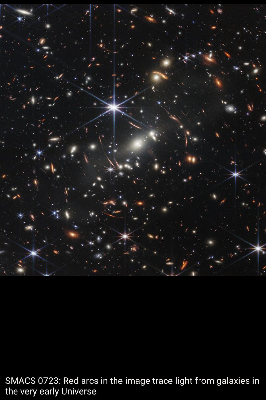 SMACS 0723 Red arcs in the image trace light from galaxies in the very early Universe