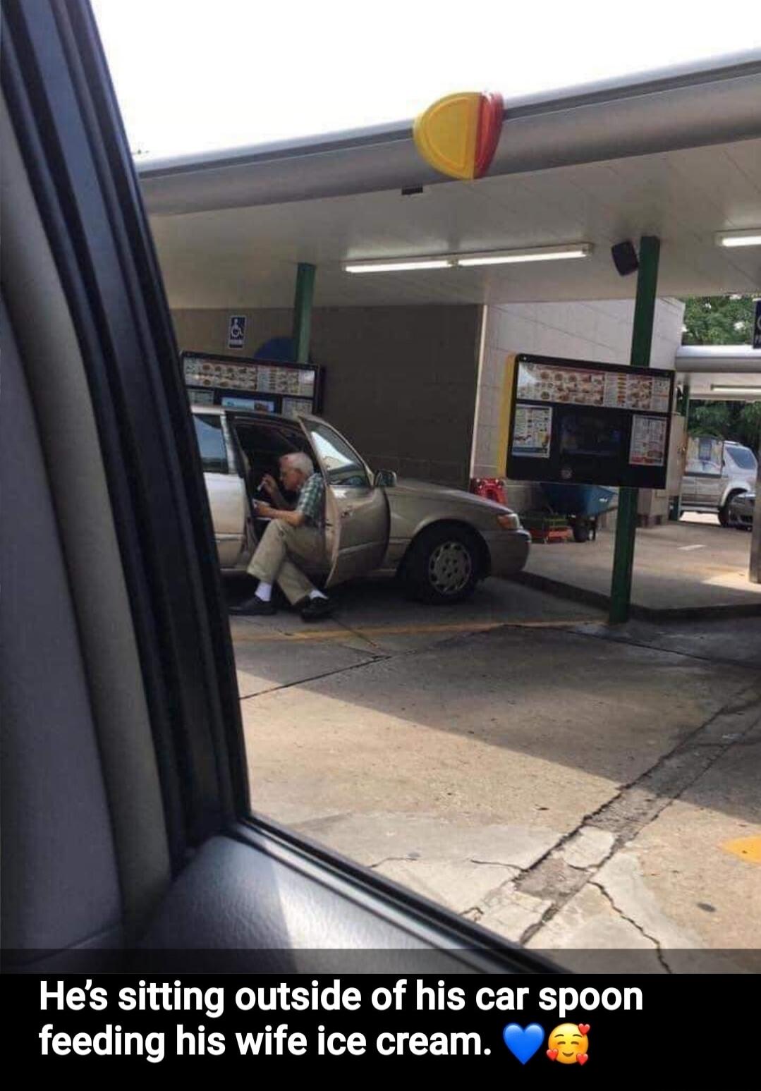 He's sitting outside of his car spoon feeding his wife ice cream. 💙🥰