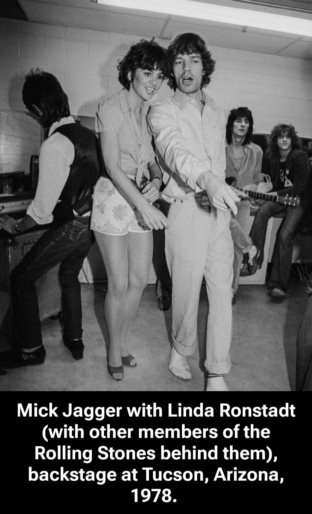 Mick Jagger with Linda Ronstadt (with other members of the Rolling Stones behind them), backstage at Tucson, Arizona, 1978.