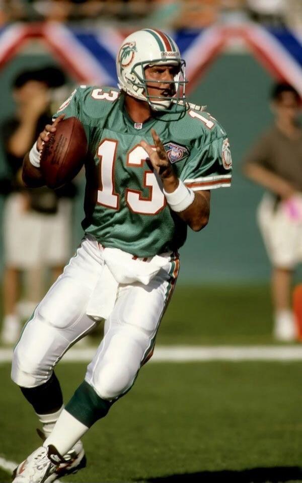 Miami Dolphins jersey number 13 (green uniform, football player in action).