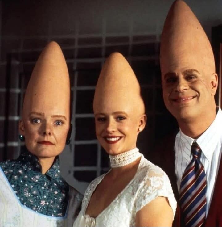 Three people with cone-shaped heads (Coneheads) posing for a photo.