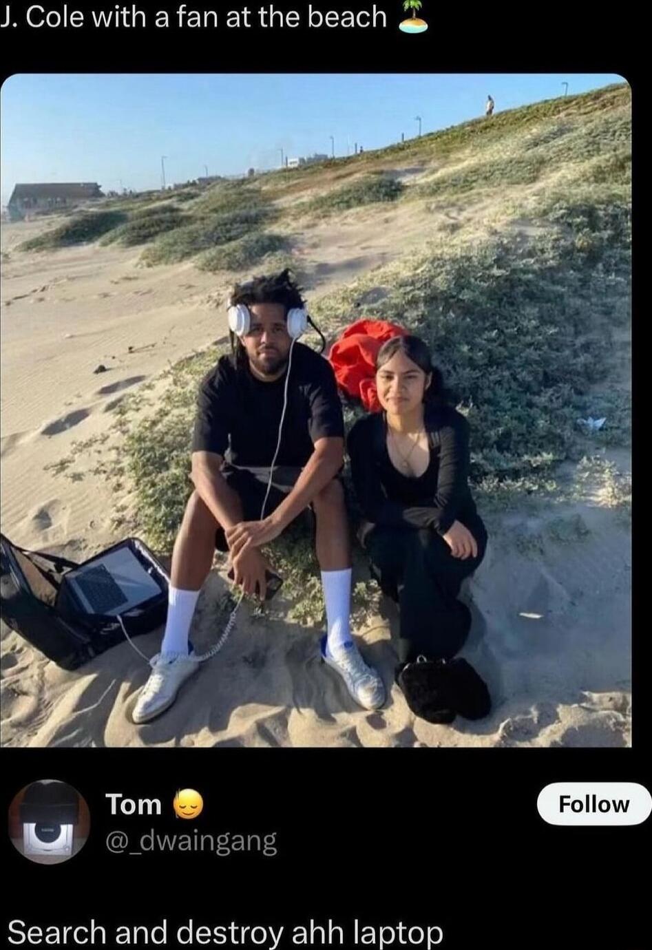 J Cole with a fan at the beach o Tom odwaingng Search and destroy ahh laptop