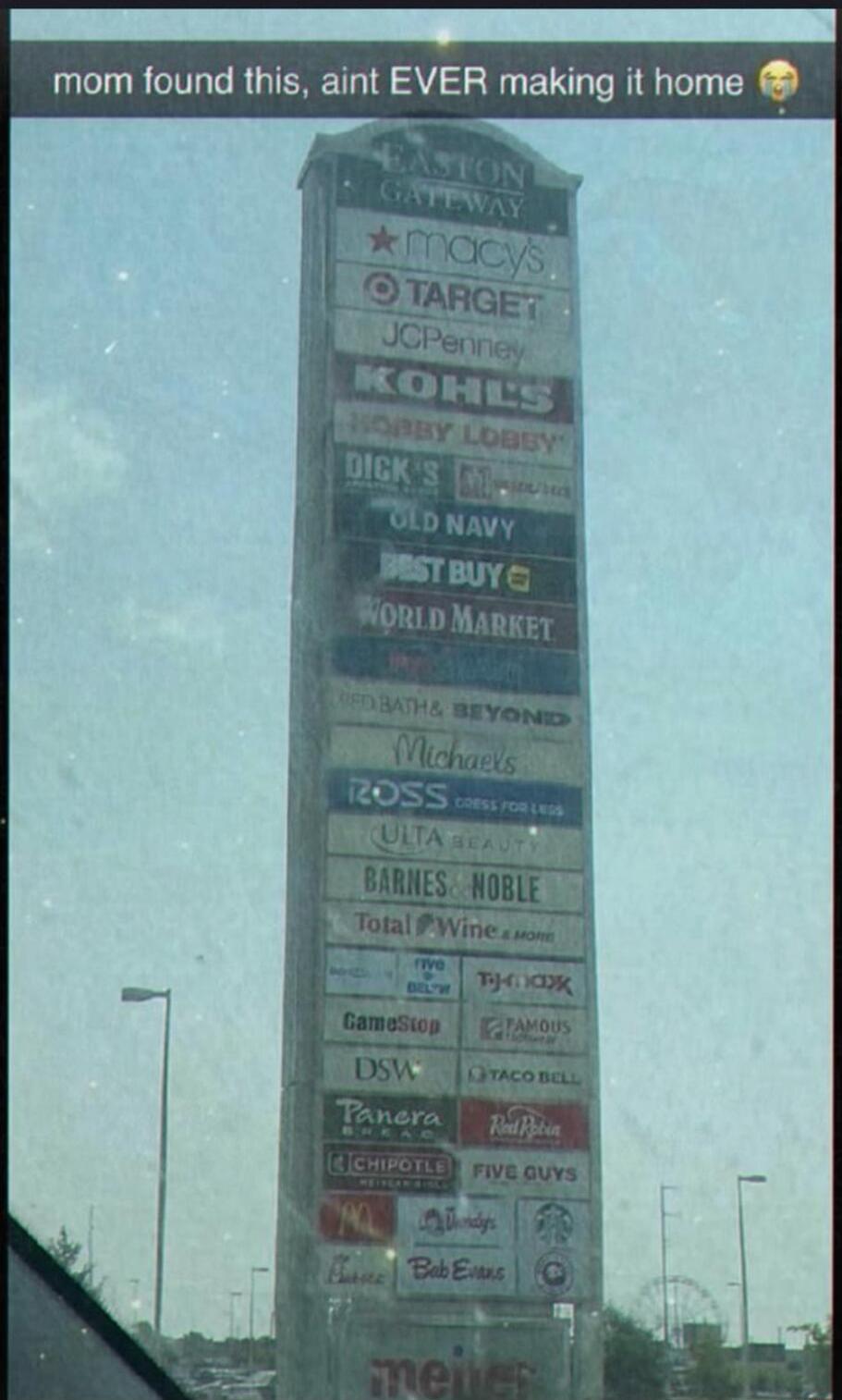 mom found this, ain't EVER making it home. The image shows a tall sign listing numerous stores like Macy's, Target, Kohl's, Best Buy, Michaels, Barnes & Noble, GameStop, Panera, Chipotle, Five Guys, and Meijer, indicating a large shopping complex or mall.