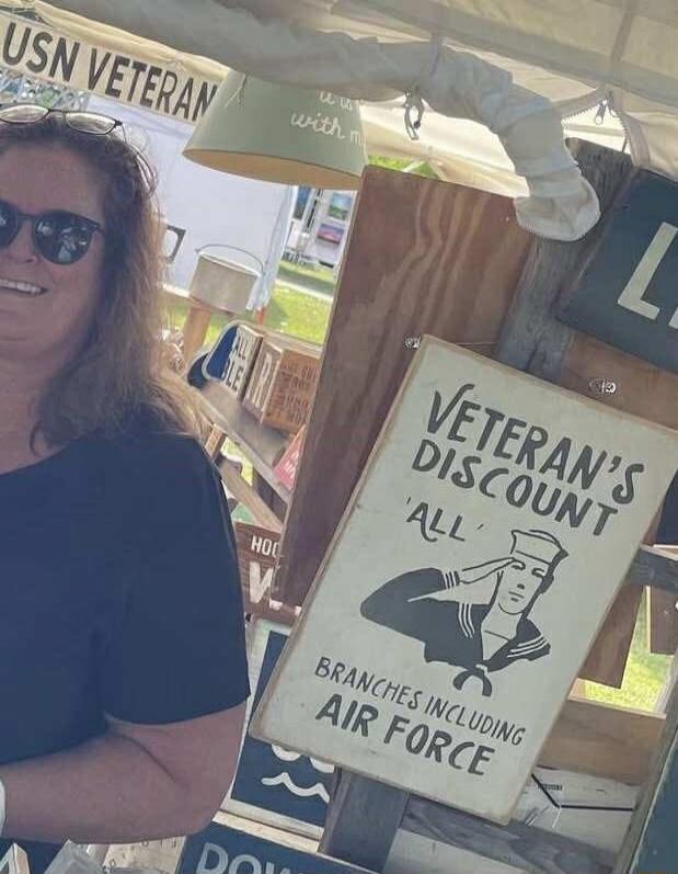 USN VETERAN. VETERAN'S DISCOUNT 'ALL' BRANCHES INCLUDING AIR FORCE. A smiling woman in sunglasses is visible. Other partial text includes 'with m', 'ALL', 'HOO', 'DOWN'.
